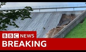 Town evacuated as dam wall collapses - BBC News